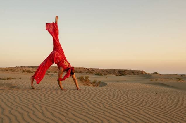 Creative Highlights Symbolfotos Junge attraktive Frau in rot gekleidet excersing auf Sanddünen in der Wüste gegen blauen Himmel Young attractive woman dressed in red excersising on sand dunes in the desert against blue sky Copyright: imageBROKER MichalakisxPpalis ibxiqx11682614.jpg ,model released, Symbolfoto ,property released