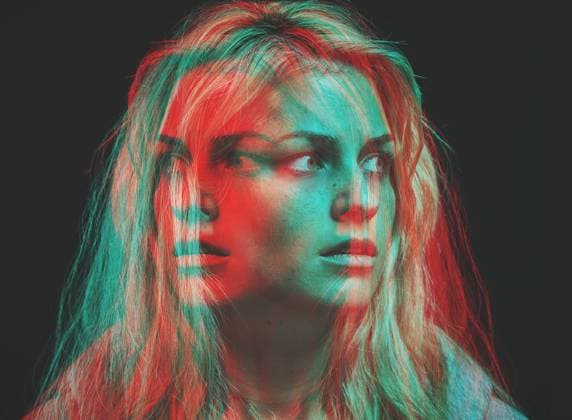 Creative Highlights Symbolfotos Psychology, bipolar and motion blur psychedelic of woman with mental health fear, insomnia and anxiety on dark background. Overlay of split emotions, schizophrenia and surreal horror of crazy face. model released property released Copyright: xwww.peopleiamges.comx