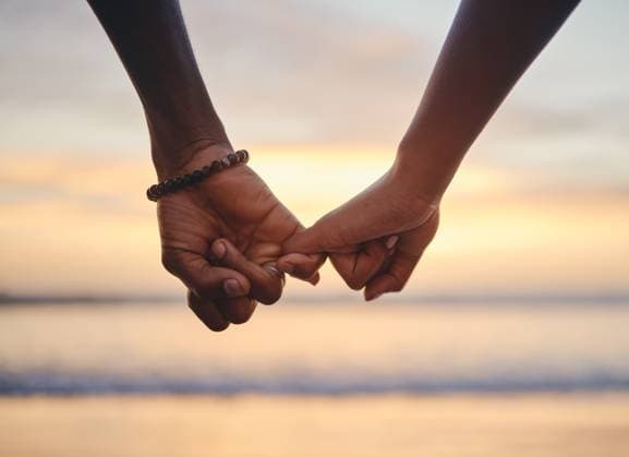 Creative Highlights Symbolfotos Love, trust and holding hands with couple at beach on Cancun vacation at sunset for happy, goals and support. Summer, vision and travel with black man and woman by the ocean together for holiday. model released property released Copyright: xwww.peopleimages.comx