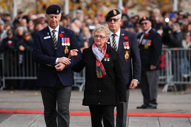 November 11, 2024, Ottawa, On, CAN: Silver Cross Mother Maureen Anderson is escorted by Steven Clark (left), national executive director of the Royal Canadian Legion, as she arrives at a Remembrance Day ceremony at the National War Memorial in Ottawa on Monday, Nov. 11, 2024. Ottawa CAN  - ZUMAc35_ 20241111_zaf_c35_009 Copyright: xSeanxKilpatrickx
