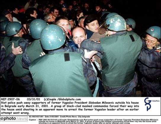 REF:2907-06 03 31 01 (c)Couple Globalphoto.com Riot police push away supporters of former Yugoslav President Slobodan Milosevic outside his house in Belgrade early March 31, 2001. A group of black-clad masked commandos forced their way into the house amid shooting in an apparent move to arrest the former Yugoslav leader after an earlier attempt went wrong. belgrade  Copyright: xx