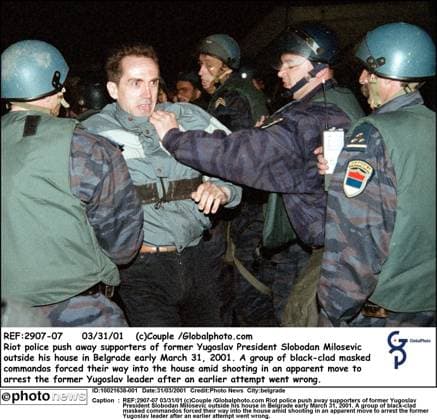 REF:2907-07 03 31 01 (c)Couple Globalphoto.com Riot police push away supporters of former Yugoslav President Slobodan Milosevic outside his house in Belgrade early March 31, 2001. A group of black-clad masked commandos forced their way into the house amid shooting in an apparent move to arrest the former Yugoslav leader after an earlier attempt went wrong. belgrade  Copyright: xx