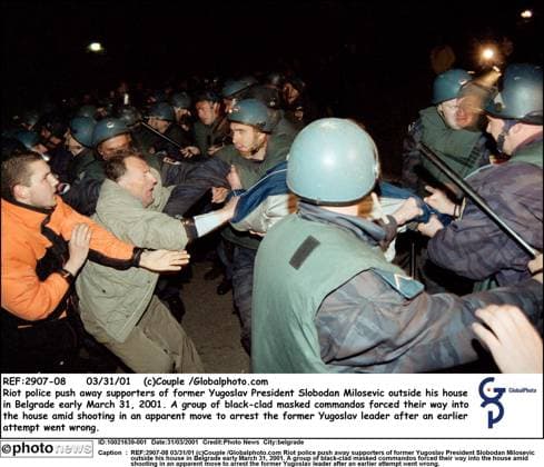 REF:2907-08 03 31 01 (c)Couple Globalphoto.com Riot police push away supporters of former Yugoslav President Slobodan Milosevic outside his house in Belgrade early March 31, 2001. A group of black-clad masked commandos forced their way into the house amid shooting in an apparent move to arrest the former Yugoslav leader after an earlier attempt went wrong. belgrade  Copyright: xx