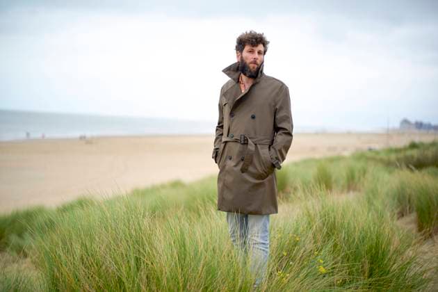 Creative Highlights Symbolbilder Man standing in tall grass on a cloudy day at the beach wearing a trench coat with a contemplative expression, Belgium bola04971 Copyright: xConnectxImagesx ,model released