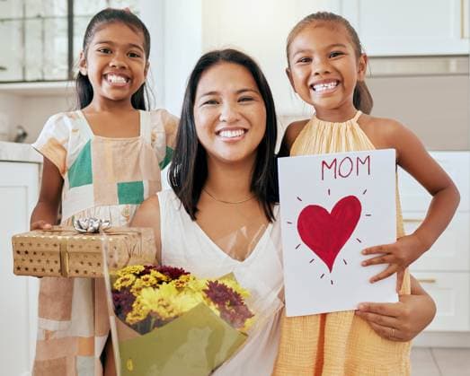 Mothers day, birthday and happy family children with gift, celebration flowers and heart card to celebrate mama. Love, youth girl and portrait of kids giving mom surprise, bouquet and present box. model released property released Copyright: xwww.peopleiamges.comx