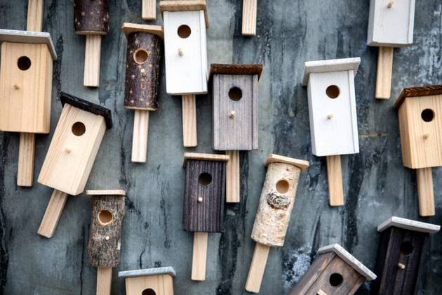 Many different wooden birdhouses on the wall, design elements. Copyright: xEdgarsxSermulisx