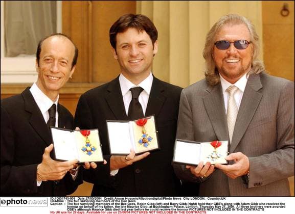 The two surviving members of the Bee Gees The two surviving members of the Bee Gees, Robin Gibb (left) and Barry Gibb (right) hold their CBE s along with Adam Gibb who received the honour on behalf of his father, the late Maurice Gibb, at Buckingham Palace, London, Thursday May 27, 2004. All three brothers were awarded CBE s although Maurice Gibb died last year before he could receive the honour LONDON. UK  Copyright: xx