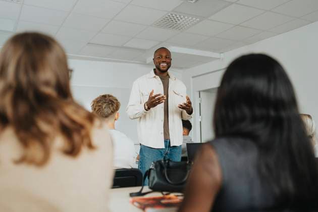 Happy male teacher gesturing while teaching high school students in classroom Sweden, Gothenburg, model released, property released Copyright: xMaskotx , MA113338 MA113338