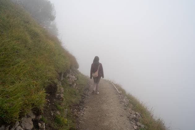 A solitary hiker traverses a foggy mountain path in Stoos, Switzerland, creating a scene of serene isolation amidst the enveloping mist Model Released JuanAlbertoRuiz_ID24623_713579_006 Copyright: xJuanxAlbertoxRuizx RECORD DATE NOT STATED