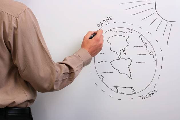 Man in a brown shirt drawing a diagram of what could happen to the earth s ozone layer. , 1653291.jpg, man, male, whiteboard, drawing, employer, employee, worker, assistant, boss, human, brown, gray, shirt, pocket, sleeve, report, review, scientist, collaboration, environment, danger, chemistry, student, sun, earth, ozone, layer, diagram, jeopardy, O3, RECORD DATE NOT STATED