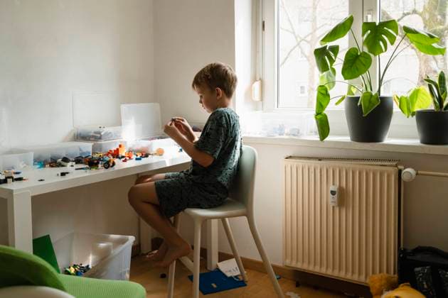 IMAGO Creative, Frühling, Frühjahrsputz Boy sorting toys on table at home model released, Symbolfoto property released, NDEF02007