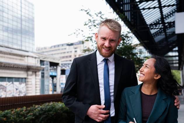 Cheerful businessman and businesswoman enjoying break near buildings model released, Symbolfoto, AMWF02972