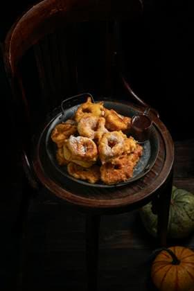 pumpkin donuts, spanish sweet dish, Bunuelos de calabaza, la receta tradicional valenciana, wooden chair. The dark background, autumnal theme, big pumpkin under chair pumpkin donuts, spanish sweet dish, Bunuelos de calabaza, la receta tradicional valenciana, wooden chair. The dark background, autumnal theme, big pumpkin under chair Copyright: xJuliaxBogdanovax JBO111124-17