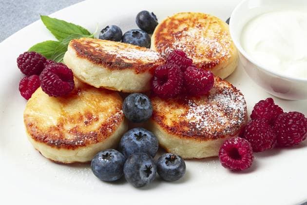 Frühstück, Hüttenkäsekuchen, mit frischen Beeren und saurer Sahne, Draufsicht, Nahaufnahme, ohne Personen Breakfast, cottage cheese cakes, with fresh berries, and sour cream, top view, close-up, no people Copyright: imageBROKER GalinaxDidebashvili ibxgai11823942.jpg