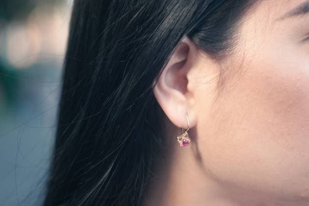 Creative Highlights Symbolbilder Right ear with hanging earring with red gemstone of a brunette woman. Close up Right ear with hanging earring with red gemstone of a brunette woman. Face Part Close up ,model released, Symbolfoto Copyright: xZoonar.com DmitryxShabanovx 14093699 ,model released, Symbolfoto ,property released