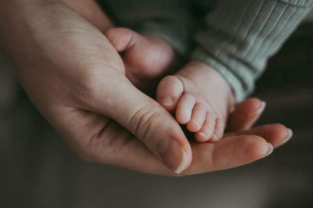 Creative Highlights Symbolbilder Close-up of mother s hand holding baby s legs Shanghai, Shanghai, China R_ITUP241126-1587515-01 ,model released, Symbolfoto