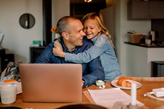 Happy boy embracing father working on laptop at home Sweden, Stockholm, model released, property released Copyright: xMaskotx , MA114396 MA114396