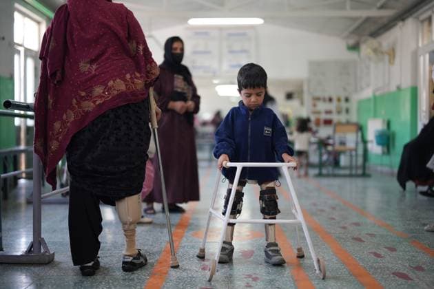 (241202) -- KABUL, Dec. 2, 2024 -- People with prosthetic limbs practice during a physiotherapy session at a rehabilitation center run by the International Committee of the Red Cross (ICRC) in Kabul, Afghanistan, Nov. 26, 2024. TO GO WITH Feature: Afghan mine victims denounce war, call for peace ) AFGHANISTAN-KABUL-ICRC-REHABILITATION CENTER LixAng 