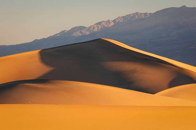 Warm light of the sunrise envelop the sand dunes at Mesquite Flat, Death Valley, California, United States of America, North America Copyright: carloxalbertoxconti 1369-292