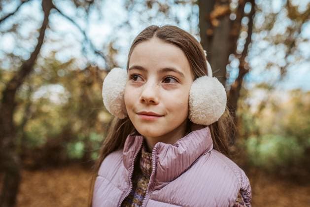 Creative Highlights Symbolfotos Outdoor portrait of young girl with fluffy earmuffs on head. Outdoor portrait of young girl with fluffy earmuffs on head. Winter season. model released