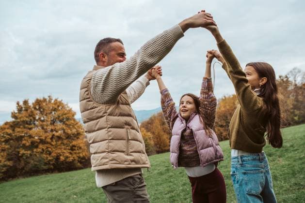 Creative Highlights Symbolfotos Father dancing with daughters, holding hands. Father dancing with daughters, holding hands. Fathers day. model released