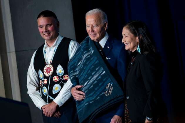 News Themen der Woche KW50 Secretary of the Interior Deb Haaland gifts President Joe Biden a blanket with Joe Biden, Champion of Indian Country 2021-2024 embroidered on the bottom during the 2024 White House Tribal Nations Summit at the U.S. Department of The Interior in Washington, DC on Monday, December 9, 2024.  WAP20241209459 BONNIExCASH