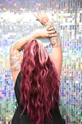Creative Highlights Symbolfotos Woman with vibrant pink hair and tattoos raising arms, back view United States, Florida, Inverness R_YWQX241210B-1595677-01 ,model released, Symbolfoto ,property released