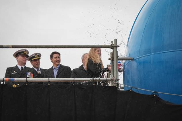 December 13, 2024, North Vancouver, Bc, CANADA: HMCS Protecteur ship sponsor Teri McKinnon, right, breaks a bottle of champagne on the bow of the new Royal Canadian Navy Joint Support vessel as HMCS Protecteur captain Landon Creasy, from left to right, Royal Canadian Navy Commander, vice-admiral Angus Topshee and Prime Minister Justin Trudeau watch, during a launch and naming ceremony at Seaspan Shipyards, in North Vancouver, B.C., on Friday, December 13, 2024. The ship is scheduled to be delivered to the Royal Canadian Navy in 2025. North Vancouver CANADA  - ZUMAc35_ 20241213_zaf_c35_086 Copyright: xDarrylxDyckx