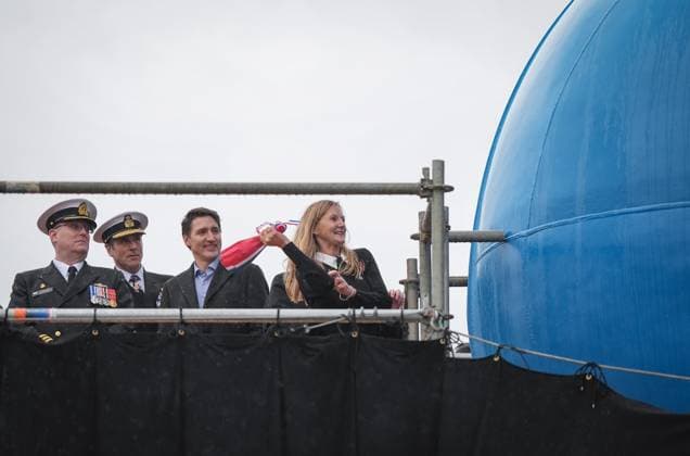 December 13, 2024, North Vancouver, Bc, CANADA: HMCS Protecteur ship sponsor Teri McKinnon, right, breaks a bottle of champagne on the bow of the new Royal Canadian Navy Joint Support vessel as HMCS Protecteur captain Landon Creasy, from left to right, Royal Canadian Navy Commander, vice-admiral Angus Topshee and Prime Minister Justin Trudeau watch, during a launch and naming ceremony at Seaspan Shipyards, in North Vancouver, B.C., on Friday, December 13, 2024. The ship is scheduled to be delivered to the Royal Canadian Navy in 2025. North Vancouver CANADA  - ZUMAc35_ 20241213_zaf_c35_089 Copyright: xDarrylxDyckx