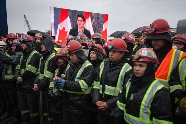 December 13, 2024, North Vancouver, Bc, CANADA: Prime Minister Justin Trudeau is seen on a video screen while speaking as workers listen during a launch and naming ceremony for the new Royal Canadian Navy Joint Support vessel HMCS Protecteur, at Seaspan Shipyards in North Vancouver, B.C., on Friday, December 13, 2024. The ship is scheduled to be delivered to the Royal Canadian Navy in 2025. North Vancouver CANADA  - ZUMAc35_ 20241213_zaf_c35_093 Copyright: xDarrylxDyckx