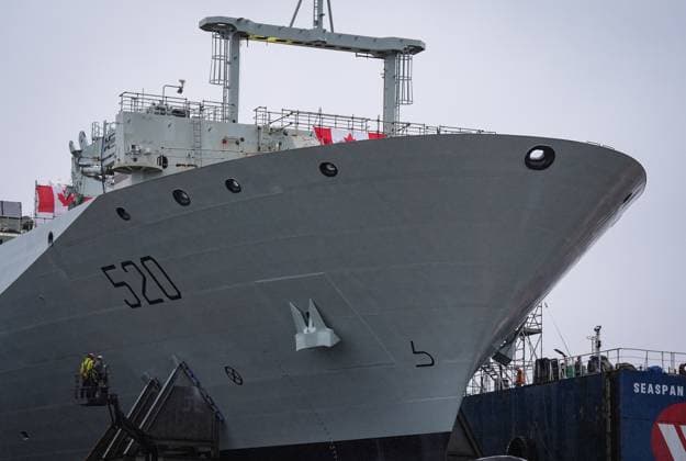 December 13, 2024, North Vancouver, Bc, CANADA: Workers are seen on a lift beside the new Royal Canadian Navy Joint Support vessel before a launch and naming ceremony at Seaspan Shipyards, in North Vancouver, B.C., on Friday, December 13, 2024. The ship is scheduled to be delivered to the Royal Canadian Navy in 2025. North Vancouver CANADA  - ZUMAc35_ 20241213_zaf_c35_097 Copyright: xDarrylxDyckx