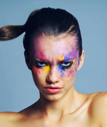 Creative Highlights Symbolfotos Paint makeup, portrait or angry woman for cosmetics isolated on gray studio background. Frown, beauty and face of serious model with color art for attitude, fantasy and abstract aesthetic in Italy. model released property released Copyright: xwww.peopleimages.comx