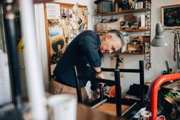 Senior male owner repairing chair while working at antique store Sweden, Stockholm, model released, property released Copyright: xMaskotx , MA114902 MA114902
