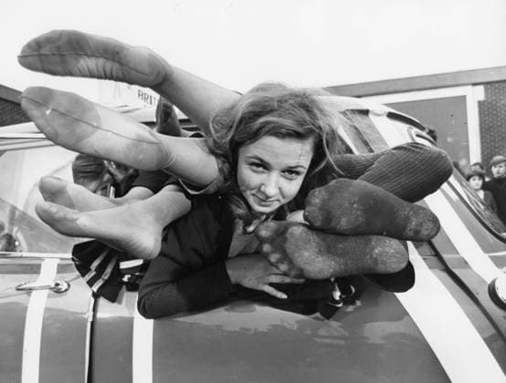 October 11,1966: Kent, England, United Kingdom: As world championships go its a bit wacky to pile 24 students into one Mini. On the other hand it is a spectacular achievement. Yesterday 24 students(11 boys an 13 girls) at the Medway College of Technology at Chatham, crammed themselves into the car. They managed to equal the world record. The student who nearly escapes all those feet is BRIGETTE PALMER, one of the 24 students who crammed into the Mini. (A Credit Image: ZUMA Press Wire) Kent United Kingdom - ZUMAk09_ 19661011_jtc_k09_819 Copyright: xKeystonexPressxAgencyx