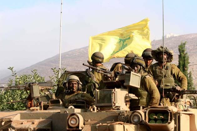 Israeli soldiers wave a tattered Hezbollah flag upon returning early morning Thursday, July 27, 2006, from fighting around the southern Lebanese village of Marun Al-Ras to a position along Israel s northeastern border with its neighbor. The international talks in Rome, which broke up yesterday without agreement on a ceasefire call, gave Israel authorization to press its offensive in Lebanon, Israeli Justice Minister Haim Ramon said today. (Pierre Tjerdman Flash 90 MCT) Avivim ISR EDITORIAL USE ONLY Copyright: xx 1033163 PierrexTjerdmanx krtphotoslive222227