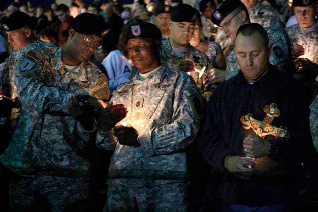 Fort Hood Shooting Maj. William McKnight, left, Sgt. Maj. Leroy Walker, Jr., and Com. Sgt. Maj. Ted Pritchard hold candles during a candlelight vigil held in Hood Stadium at Fort Hood, Texas, Friday, November 6, 2009. (Ron T. Ennis Fort Worth Star-Telegram MCT) FORT HOOD TX US EDITORIAL USE ONLY Copyright: xx 1080418 RonxT.xEnnisx krtphotoslive380736