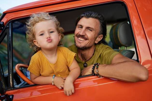 Cute girl puckering by father inside caravan on vacation model released, Symbolfoto property released, ANNF00710