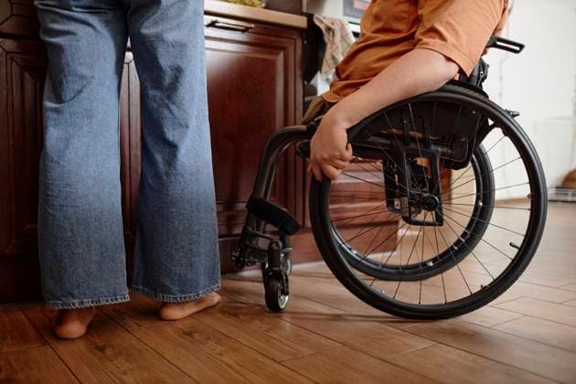 Cropped shot of unrecognizable wheelchaired boy helping mother with breakfast at home model released, Symbolfoto property released, KPEF00883