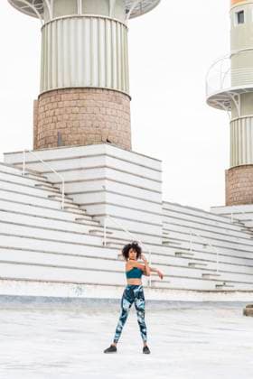 Creative Highlights Symbolbilder Woman stretching arms near steps at park model released, Symbolfoto, MEGF01127