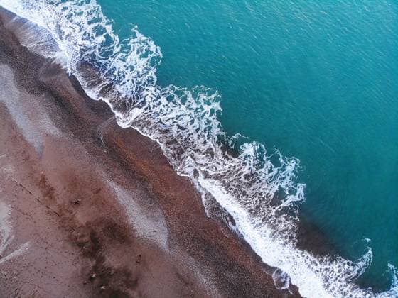 Creative Highlights World Aerial view of sea waves near the sand beach Kobuleti, Adjara, Georgia R_NIBA241229B8-1615525-01