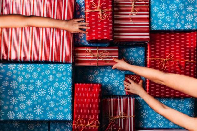 Hands Reaching for different Red and Blue Gifts Tulsa, Oklahoma, United States CR_KRRY241230-1608675-01