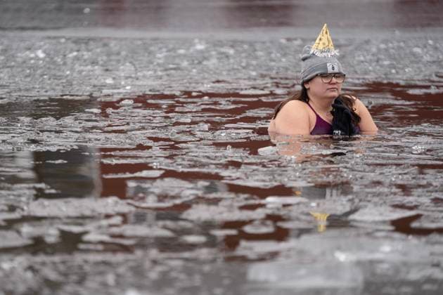 January 1, 2025, Dartmouth, Ns, Canada: A person wears a party hat while swimming in the ice-filled water in Lake Banook during the annual polar bear swim on New Year s Day in Dartmouth, N.S., Wednesday, Jan. 1, 2025. Dartmouth Canada  - ZUMAc35_ 20250101_zaf_c35_025 Copyright: xDarrenxCalabresex