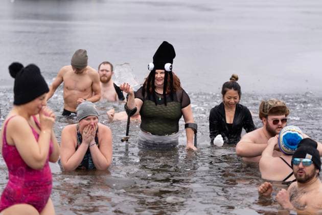 January 1, 2025, Dartmouth, Ns, Canada: Vicki Morton holds a chunk of ice while swimming in the ice-filled water in Lake Banook during the annual polar bear swim on New Year s Day in Dartmouth, N.S., Wednesday, Jan. 1, 2025. Dartmouth Canada  - ZUMAc35_ 20250101_zaf_c35_031 Copyright: xDarrenxCalabresex