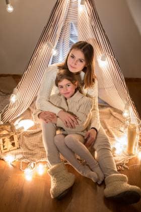 Beautiful mother and daughter, Christmas eve, sitting in the cosy interior. New year, model released, , 44388564.jpg, blanket, braid, cabin, candle, celebration, cheerful, child, christmas, cute, daughter, decoration, down, evening, family, fashion, fireplace, friends, gift, girl, godmother, happy, holiday, house, hug, joy, knitted, laminate, lamp, laugh, light, model, mother, new, pillow, playful, portrait, sister, sit, smile, studio, sweater, symbol, tent, winter, woman, wood, year, young, new year RECORD DATE NOT STATED