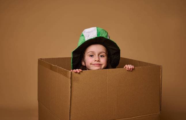 Adorable 4 year old child girl with a Leprechaun hat peeks out from under a cardboard box and smiles cutely at the camera. Happy St. Patrick s Day. Studio shot on beige background with copy space, model released, , 45261886.jpg, baby girl, children, Saint Patricks Day, shamrock, ireland, plant, celebration, clover, decoration, fairytale, leprechaun, hat, child protection, kids, concepts, positive emotions, home, secutity, care, emotional portrait, infant, adorable, beautiful, pretty, charming, innocence, cardboard box, beige background, copy space, advertisement, advertising, studio shot, pajamas, Caucasian, European, relocation, playful, container, happiness, inside, hiding, childhood, people, cheerful, interior, lifestyle, smile, toddler RECORD DATE NOT STATED