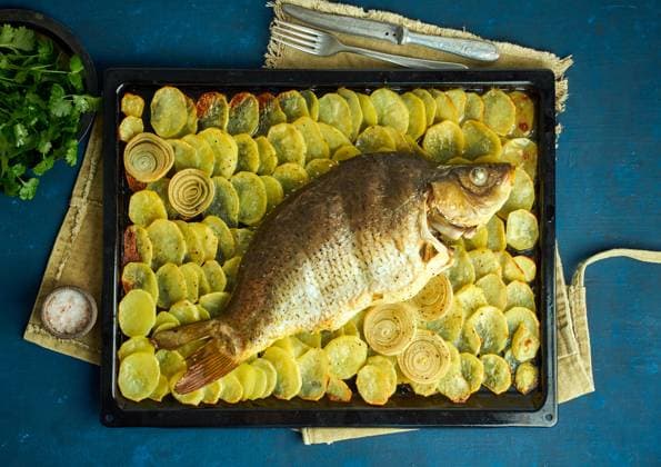Baked carp, whole fish from the oven with sliced potatoes on a large tray on dark blue background. Traditional European Polish dish, suitable for a Christmas table , 45956344.jpg, carp, event, fish, potatoes, oven, whole, dinner, cooking, recipe, dish, table, prepared, parsley, peeled, meal, gourmet, fresh, food, diet, cuisine, golden, festive, fillet, holiday, herb, crispy, hot, lunch, natural, poland, polish, portion, roasted, slice, spices, tasty, tradition, traditional, healthy, cooked, breaded, christmas, batter, baked, appetizing RECORD DATE NOT STATED