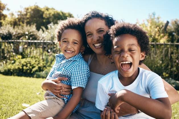 Creative Highlights Symbolbilder Black family, portrait and excited on grass for travel, summer vacation and relax with hug. Mother, children and smile in nature park with love, relationship development or happy for holiday in Kenya. model released property released Copyright: xwww.peopleimages.comx