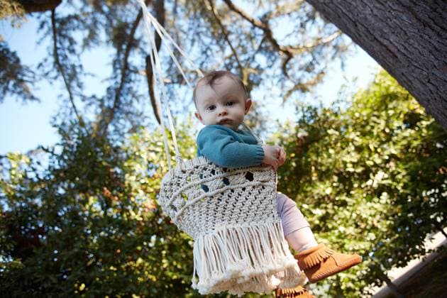 Creative Highlights Symbolbilder Baby On Swing Looking At Camera Los Angeles, California, United States CR_KECOAN250114A-256340-01 ,model released, Symbolfoto