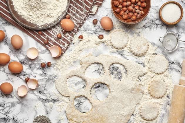 Close-up shot. Top view of a kitchenware and baking ingredients on a marble table background. There are some eggs and an eggshell, flour on a brown striped apron, sieve, sugar, scattered hazelnuts, rolling pin, billet for cookies, cupcake mold, rolled dough on a table. , 47712946.jpg, flour, table, background, cooking, food, kitchen, pastry, preparation, white, egg, butter, top, above, bake, dough, homemade, utensils, cake, basic, easter, meal, product, sieve, rolling pin, view, recipe, cupcake, mold, ingredient, milk, wooden, brown, traditional, decoration, rustic, hazelnuts, sweet, dessert, menu, pie, preparing, christmas, utensil, powdered, close-up, nobody, domestic, striped, apron, billet RECORD DATE NOT STATED