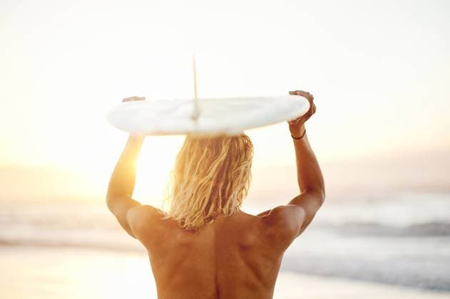 Creative Highlights Symbolbilder Back, surfing and sport with a man on the beach, holding his surfboard over his head in the water. Surf, view and ocean with a shirtless male surfer standing in the sea for training from behind. model released property released Copyright: xPeopleImages.comx-x 2429311x